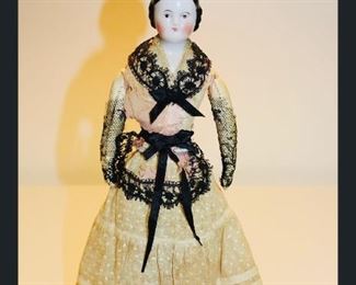 (Rare) 10” brown eyed China.  Purchased from Richard Wright- French leather body, arms, legs.  Ivory and pink with black lace trim.  