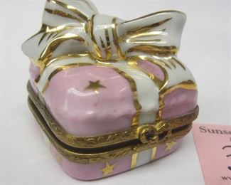 A porcelain trinket box  in the form of a wrapped gift.  Peint Main mark on lid.  1 5/8" wide