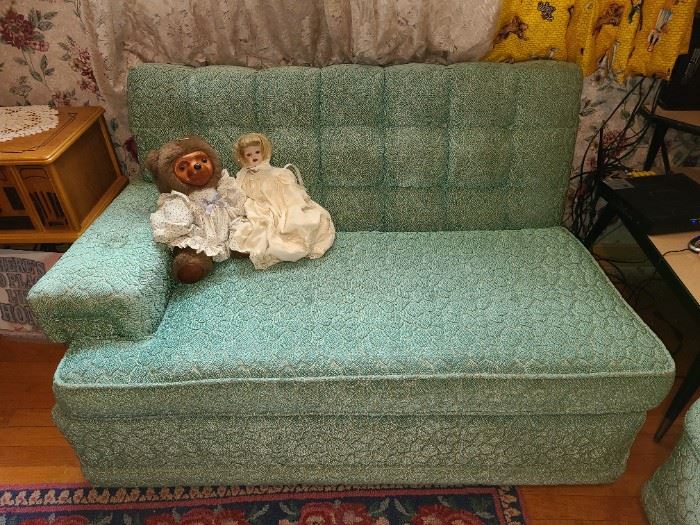 One part of a teal couch with wheels