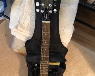 Les Paul Gibson guitar with case, amplifier, strap and cord.
