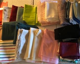 Just a few of the fabric pieces.  Scraps, 1/4 yards to yardage.   In addition to fabric, there are three sewing machines, trim, lace, ribbons, thread, notions, scissors.  Sewing books and patterns.  Yarn, needles, hoops.