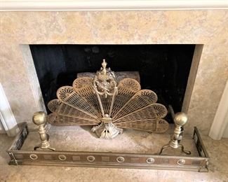 Fan-shaped fireplace décor; brass fire fender