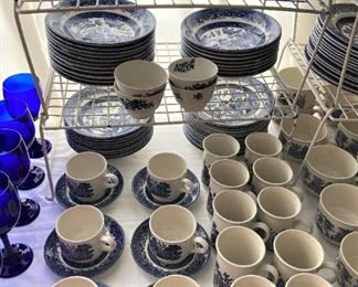 Lots of coffee cups and other plates and bowls