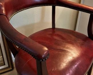 One of three red leather office chairs