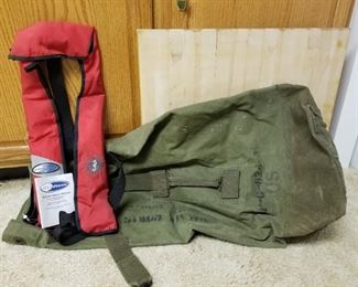 Military duffel bag and Air Force (brand) life jacket auto inflatable.
