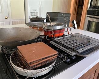 39.  kitchen stuff invluding posts, wok, trivets, copper wide pan and nice cast itron bean pot $60