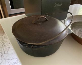 39.  kitchen stuff invluding posts, wok, trivets, copper wide pan and nice cast itron bean pot $60