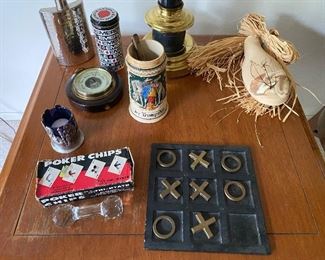 49. Decorative objects including flask, stein, barometer, pokerchips, waterford dumbell, tik tak toe and wall vase $40