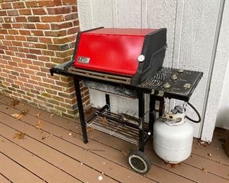 65.  Cool red Weber propane grill $45