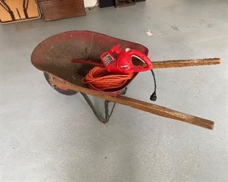 97. Trimmer and wheel barrow $25