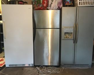 Freezer and two refrigerator/freezers 