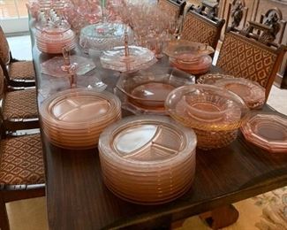 Large group of pink depression glass being sold as one unit.
