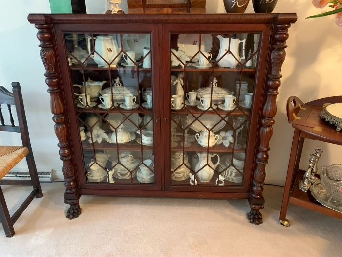 Antique American Empire bookcase with claw feet & carved columns.