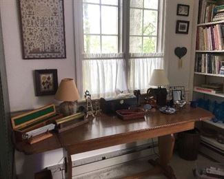 Nice wood desk with kaleidoscopes, lamps,  framed pressed flowers, and more