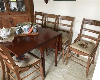 Drop leaf cherry table, antique chairs with needlepoint seats