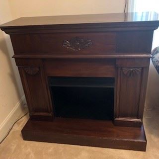 Freestanding Fireplace, dark walnut, carved details. Minor damage on edges of hearth portion. NOT ELECTRIC. $300.00                                                                  
Debit and Credit Accepted.    