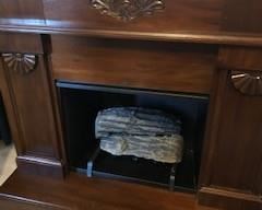 Logs and grate included in fireplace