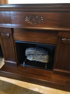Logs and grate included in fireplace