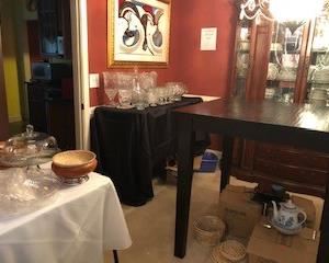Dining room area. High Dining table for sale, some surface damage, but easy to refinish. Crystal, punch bowls, Paula Deen dish sets, Japanese Tea set, Japanese signed framed painting.