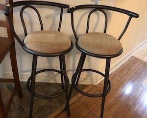 Set of Bar stools, iron and upholstered, swivel with round footrests. 