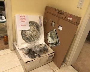 Tiffany pendant lamp, still in original box, bronze hanging chain and canopy; Large wall mirror clock with additional mirrored details, still new in box (needs new clock hands but otherwise new)