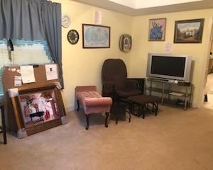 Brown swivel rocker and rocking ottoman, TV's, art and clocks