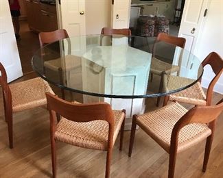 Glass top pedestal table with 7 Neils O. Moller MCM teak chairs