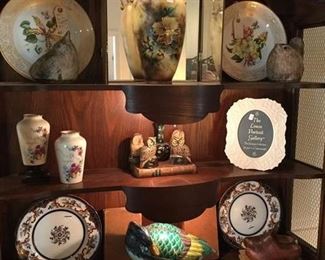 SHOWING THE UPPER PART SECRETARY 3 LIGHTED SHELVES  LIGHS BEHIND SHAPED SHIELDS      {PLEASE NOTE ON THE TOP SHELF ARE TWO OF OUR 4 PIECES OF MCCARTY POTTERY  THE UNSHOWN PIECES ARE A SHELL AND ANOTHER BIRD WITH CHIPPED BEAK]