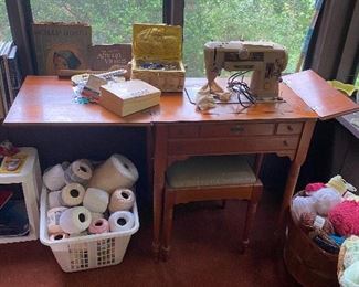 Vintage sewing machine and lots of sewing notions