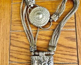$125  Antique silver tone belt multistrand with pendant 31" L. 