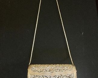 $70 Ornate carved hand bag on chain 7.25" W, 2.25" D, 24" H. 