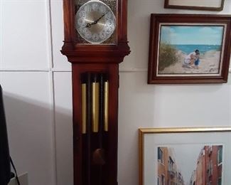 Grandfather clock and framed artwork.