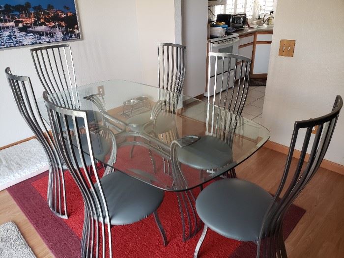 Metal and glass dining table and six chairs