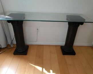 glass side table with two black pillars 50in by 16 in by 27 inches high