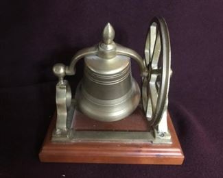 Metal bell on wood base.