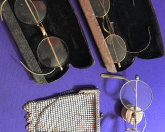 antique eye glasses and metal purse