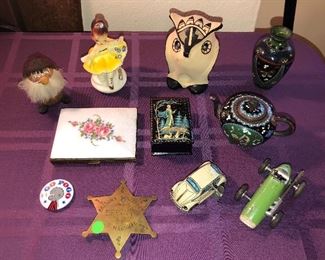 Wooden elf, Josef Originals “Little Lulu”, Jemez Pueblo owl (SW pottery), cloisonné mini vase & teapot, guilloche cigarette case, repro sheriff’s badge, tin litho wind-up VW beetle, green Schuco micro racer
