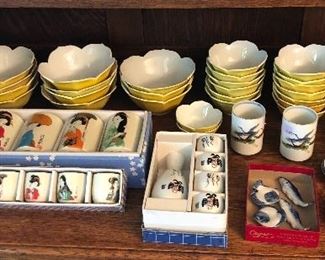 Assorted Japanese items: Yellow lotus bowls, sets of tea cups, sake sets, chopstick rests