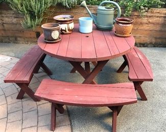 44” round picnic table with 4 curved benches, assorted planters