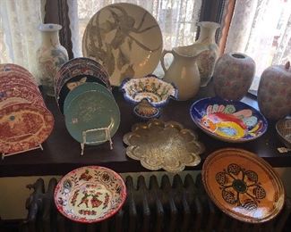 Red transferware plates, newer Asian vases & jars, studio pottery 18” charger, primitive stoneware pitcher, old etched brass tray, Spanish & Italian bowls, French silverplate basket