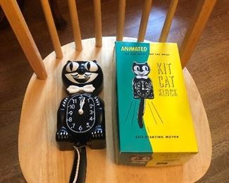 Vintage electric Kit Kat clock with box (does not run) - sitting on one of 4 blonde Windsor dining chairs