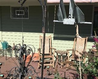 Variety of shepherds hooks with hanging planters and boat anchor