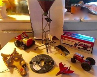 circa 1916 Metal Toy loader 3 removable parts, Ertyl Kenworth State Truck w barrel banks(never opened), Antq Red metal Tractor, Red metal Navy Cutlass, Cast Iron 6' damper,Micket mouse battery op tractor.....