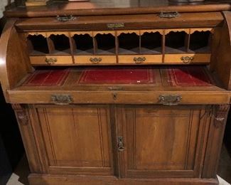 ANTIQUE ROLL TOP DESK w/RED LEATHER INSIDE, COLUMNED DOCUMENT DRAWERS & SCROLLED VALANCES. 