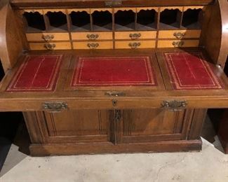 ANTIQUE ROLL TOP DESK w/RED LEATHER PULL OUT, COLUMNED DOCUMENT DRAWERS & SCROLLED VALANCES. DATES BACK TO 1800's 