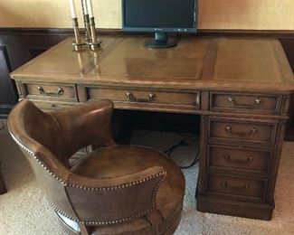 EXECUTIVE DESK AND LEATHER SWIVEL CHAIR TRIMMED IN NAILHEAD
