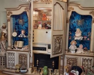 Spectacular vintage 4  piece bar wall unit. Intricately detailed. Glass with foiled blue back ground. Can be converted into a entertainment center. There are 2 crystal chandeliers, center lights when door is opened, working faux fireplace at bottom. Side cabinet storage at bottom. 
