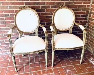 #5- pair of white covered gilded chairs some stains on the seats 23 inches wide $200 for the pair