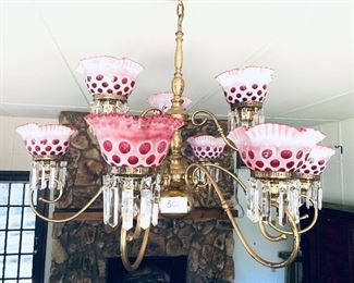 Brass and blown cranberry glass chandelier with  prisms
 41 inches wide by 34 inches long $985