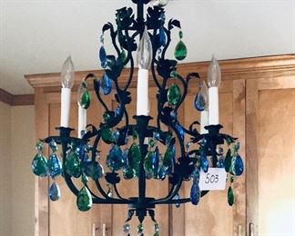 Black metal chandelier with blue and green prism 19 inches wide by 29 inches long $400